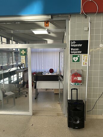 AED im klaren Wandkasten neben dem Schwimmmeisterraum 